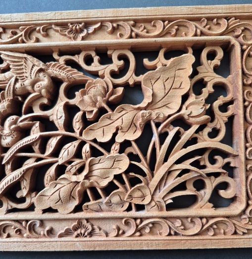 Carved decorative wooden panel, featuring birds.