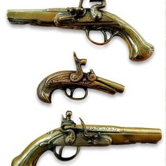 Three vintage brass pistols