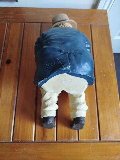 Resin sculpture of a seated boy