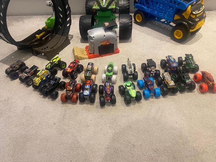 Hot Wheels Monster Trucks collection with transporter and track