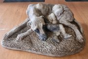 Sculpture of a boy sleeping with a dog