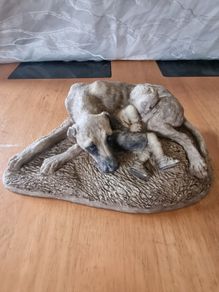 Sculpture of a boy sleeping with a dog