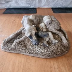 Sculpture of a boy sleeping with a dog