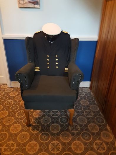 Queen Anne wingback chair / Quirky Ships Commander's uniform.