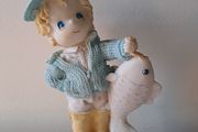 Vintage bisque boy holding a fish