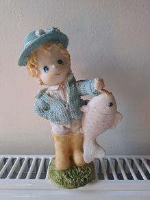 Vintage bisque boy holding a fish