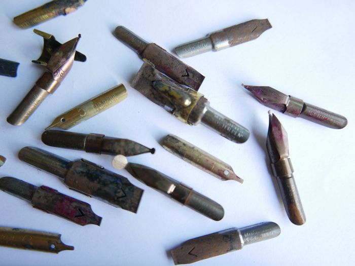 Vintage dip pen with collection of assorted nibs