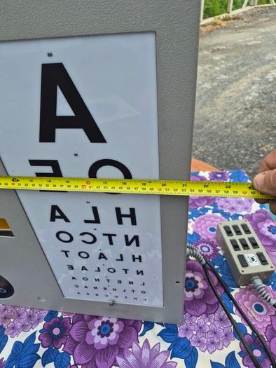 vintage optician's illuminated eye test chart, commonly used in the mid-20th century.