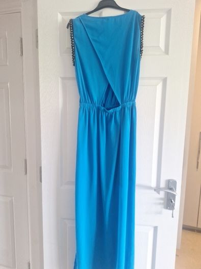 Ladies vibrant blue full-length dress with sleeve detail and back detail.