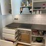 Modern white kitchen units and tall larder storage Image 6