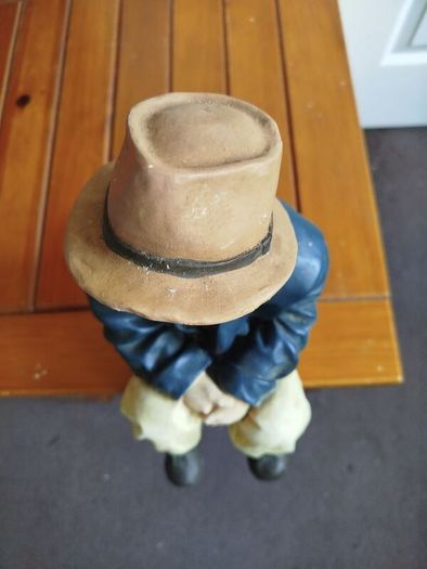 Resin sculpture of a seated boy