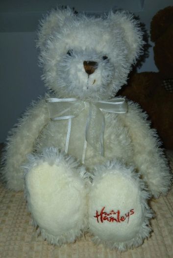 White hamleys teddy bear baby gift.  Soft white teddy with white bow.
