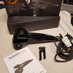 BaByliss PRO Perfect Curl styling tool, highlighting its "Auto Curl technology for creating effortless curls.