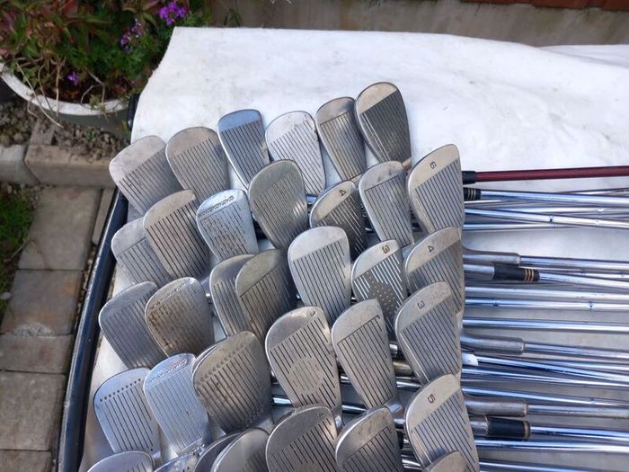 A selection of Golf clubs. Bags and golf balls.