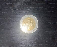 Greek man riding a bull 2 euro coin with S marking in the bottom star 2002