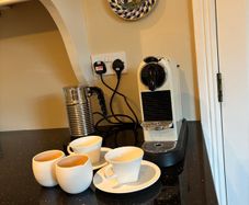 Nespresso espresso machine, milk frother and cups