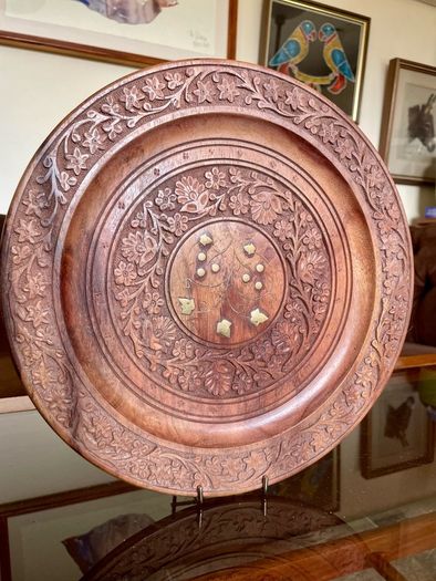 Beautiful vintage hand-carved wooden tray featuring an intricate floral border and a decorative brass inlay geometric star motif in the centre. The craftsmanship is detailed and very tactile, giving this piece a rich, warm character. The tray is solid and
