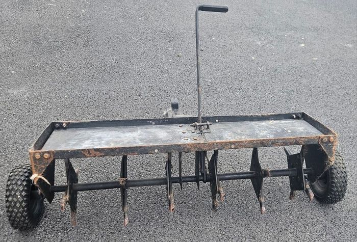 Tow behind lawn aerator