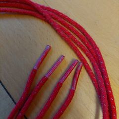 Red laces with grey fleck from Nike Air Max Plus trainers