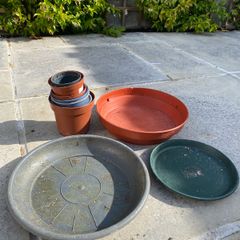 Selection of small plant pots and large plant saucers