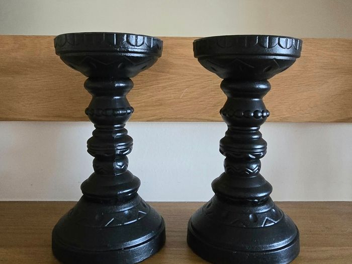 A pair of black candle holders