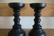 A pair of black candle holders