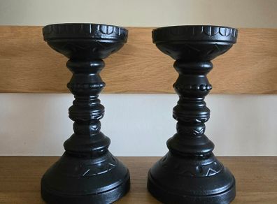 A pair of black candle holders