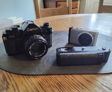 canon A-1 with 50mm lens & winder, also canon power shot A3000 both for spairs/ repair