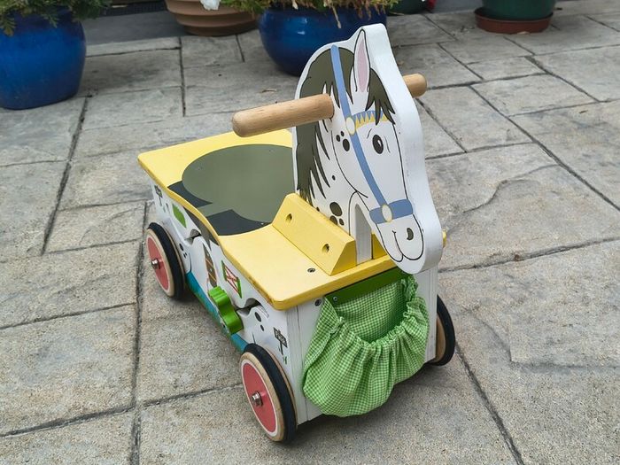 Wooden horse-themed ride-on toy in good used condition
