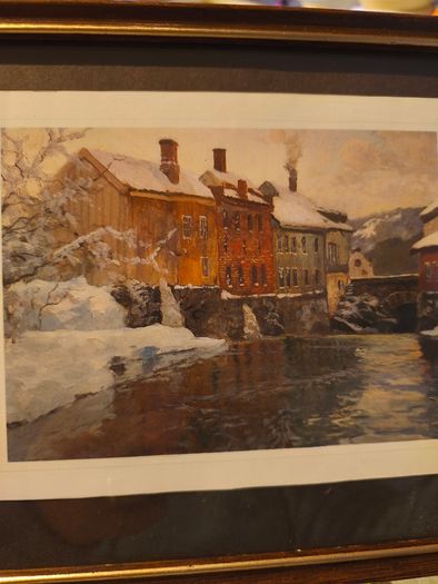 Framed print of  Snow-Covered Buildings by a River by Fritz Thaulow (1847 - 1906).