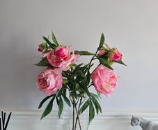 artificial pink flowers in a glass vase