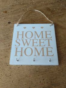 rustic wooden "Home Sweet Home" plaque  decorative wall art piece  small heart motifs, and metal hooks for keys