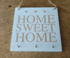 rustic wooden "Home Sweet Home" plaque  decorative wall art piece  small heart motifs, and metal hooks for keys