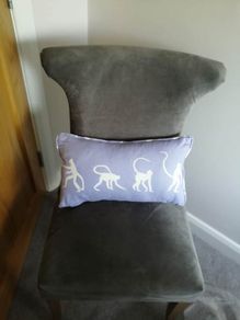 Purple children's bed cushion with monkey print