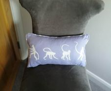 Purple children's bed cushion with monkey print