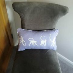 Purple children's bed cushion with monkey print