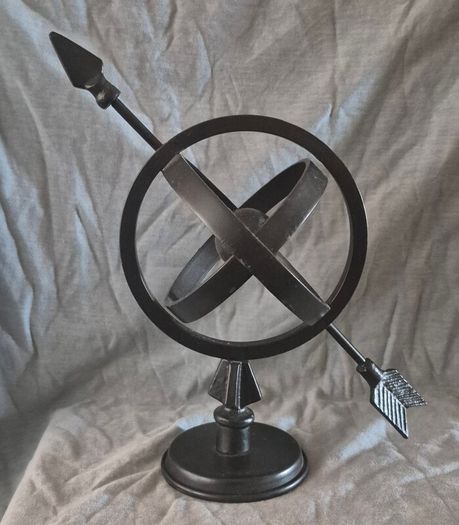 Metal globe and arrow.