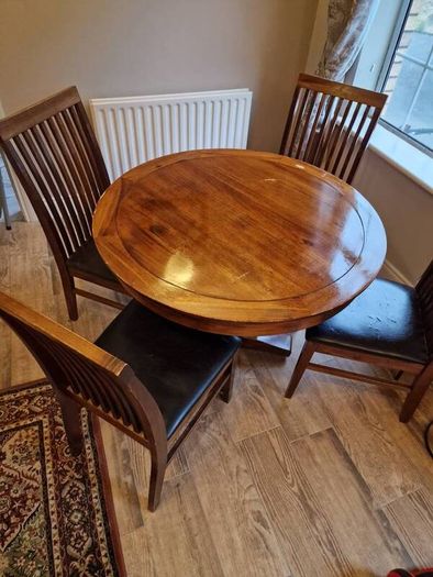 Round wooden table and four chairs