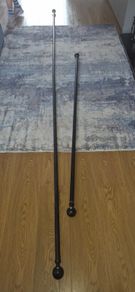 2 Curtain Poles and 2 Hold Backs