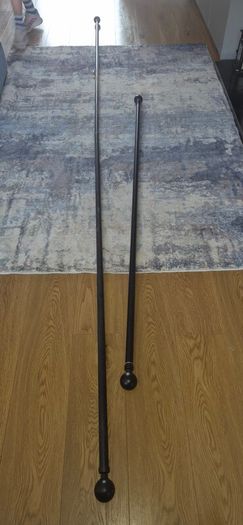 2 Curtain Poles and 2 Hold Backs