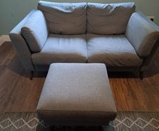 Two seater grey couch with footstool