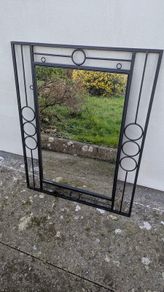 Mirror in a black metal frame