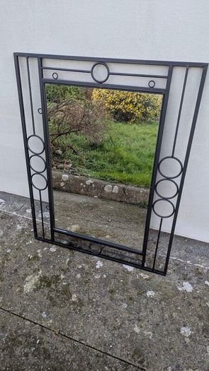 Mirror in a black metal frame