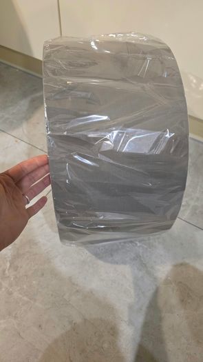 Brand new grey drum lampshade still sealed in its original plastic wrapping.