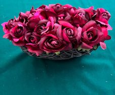 Free Artificial Red Roses in a Basket. 28 cm (w) x 17 cm H