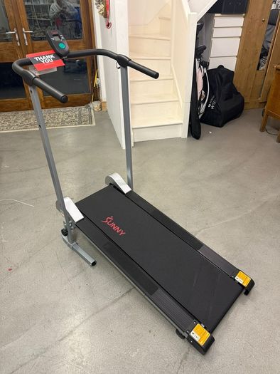 Manual Compact foldable treadmill with transportation wheels for easy portability.   Folded dimension: 20Lx23Wx50h in.
