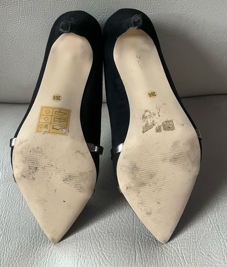 Black high heeled shoe with silver detail front