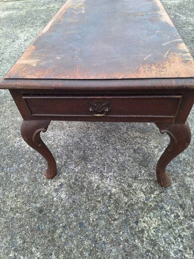 Antique wooden coffee table in need of restoration