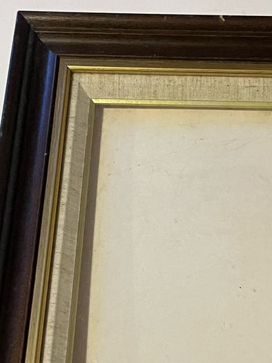 frame A rich dark-wood and gilt picture frame featuring a textured fabric mat liner.