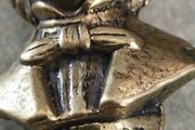 This brass bust appears to be a vintage docertive item / paperweight and pipe tamper or desk accessory depicting the composer Schubert, featuring his name clearly inscribed on the base.